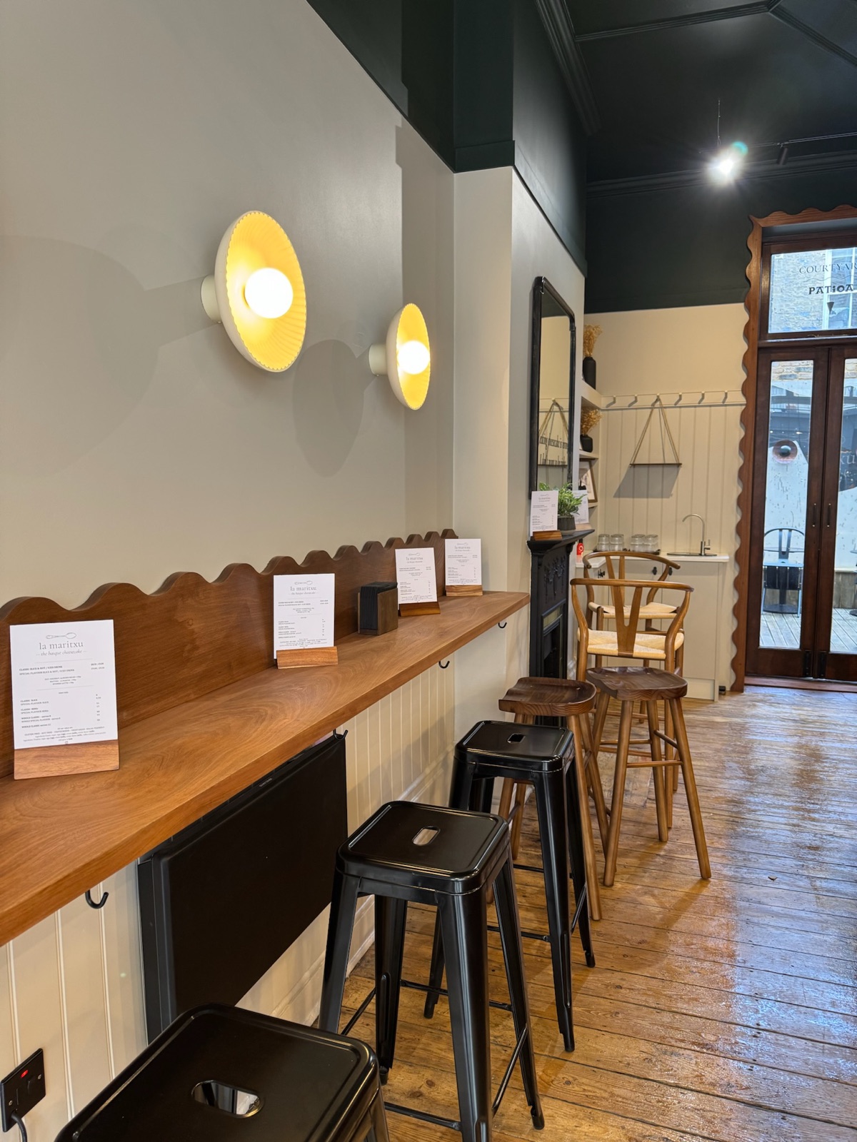Inside La Maritxu's Greenwich store: panelled walls, shelf seating and pendant lights