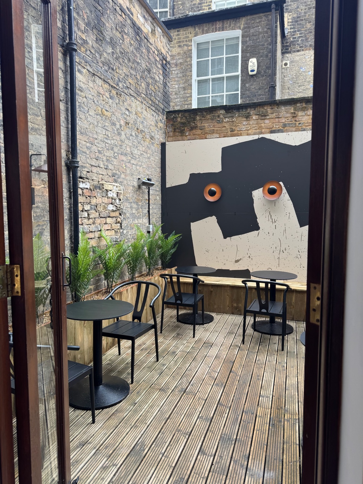La Maritxu Greenwich outdoor patio with mural and seating